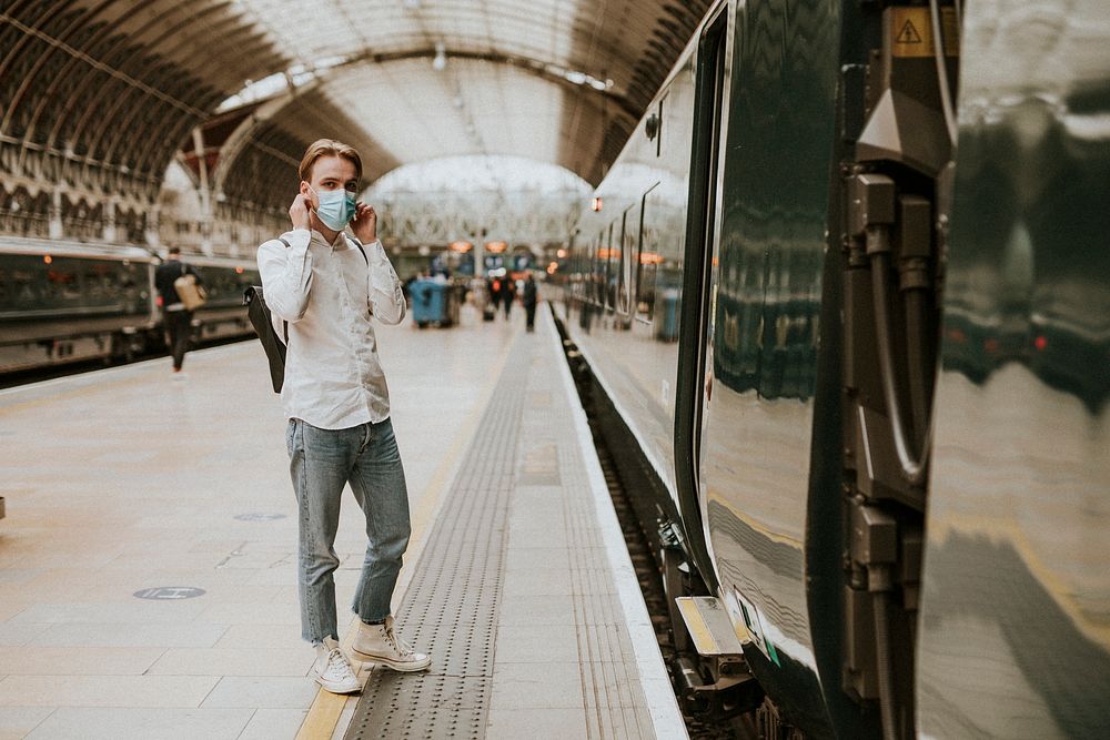 Man waiting for a train on a platform 