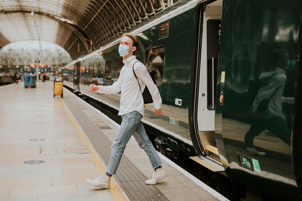 Man getting off a train onto a platform