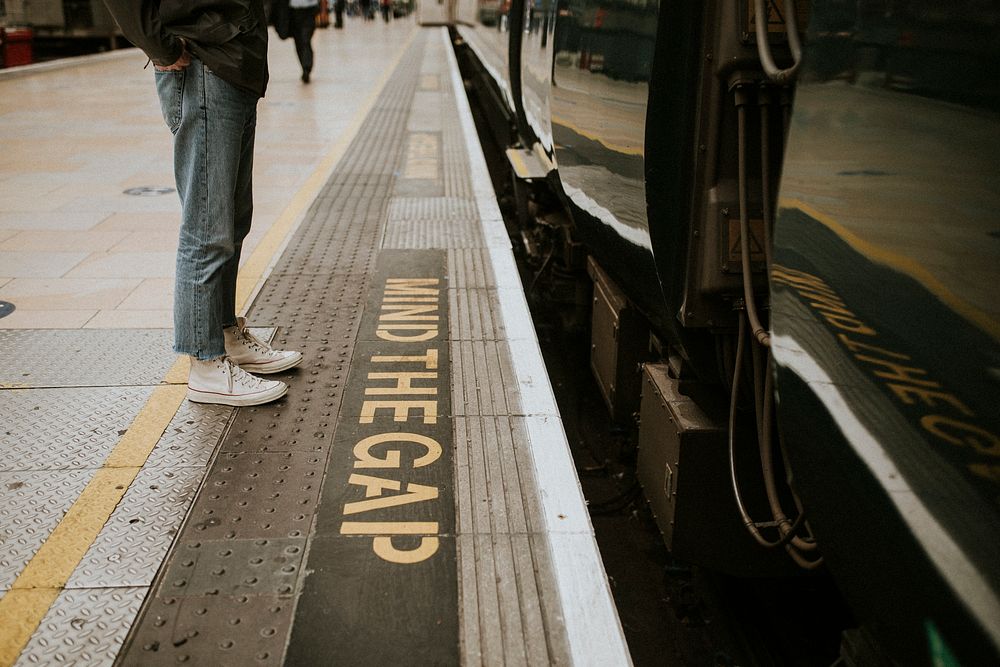Man waiting for a train on a platform 