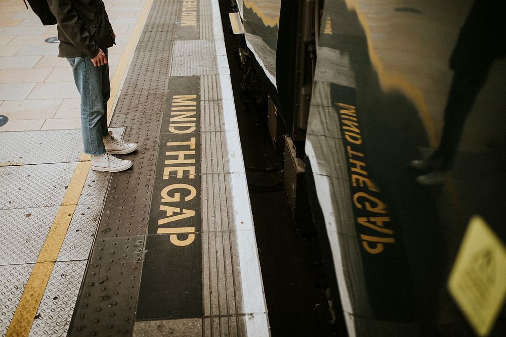 Man waiting for a train on a platform 