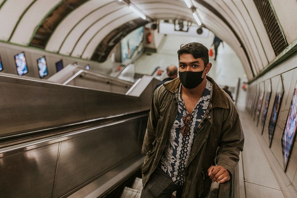 Man using escalator at an underground station in the new normal 