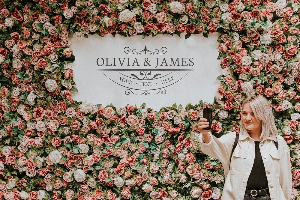 Wedding sign mockup psd with a woman taking a selfie by the flower wall installation