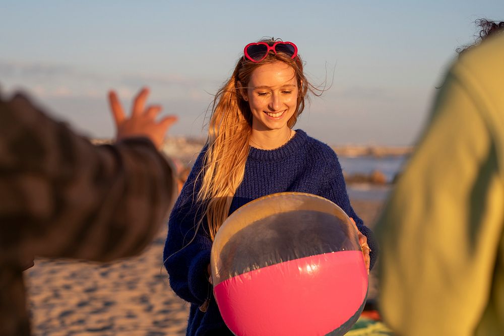 Teen girl holding beach ball, on a summer holiday in Venice Beach, Los Angeles