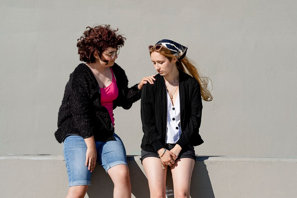 Teen comforting friend, youth mental health social issue