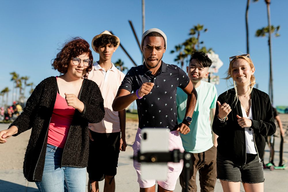 Video content creator dancing with friends in Venice Beach, Los Angeles