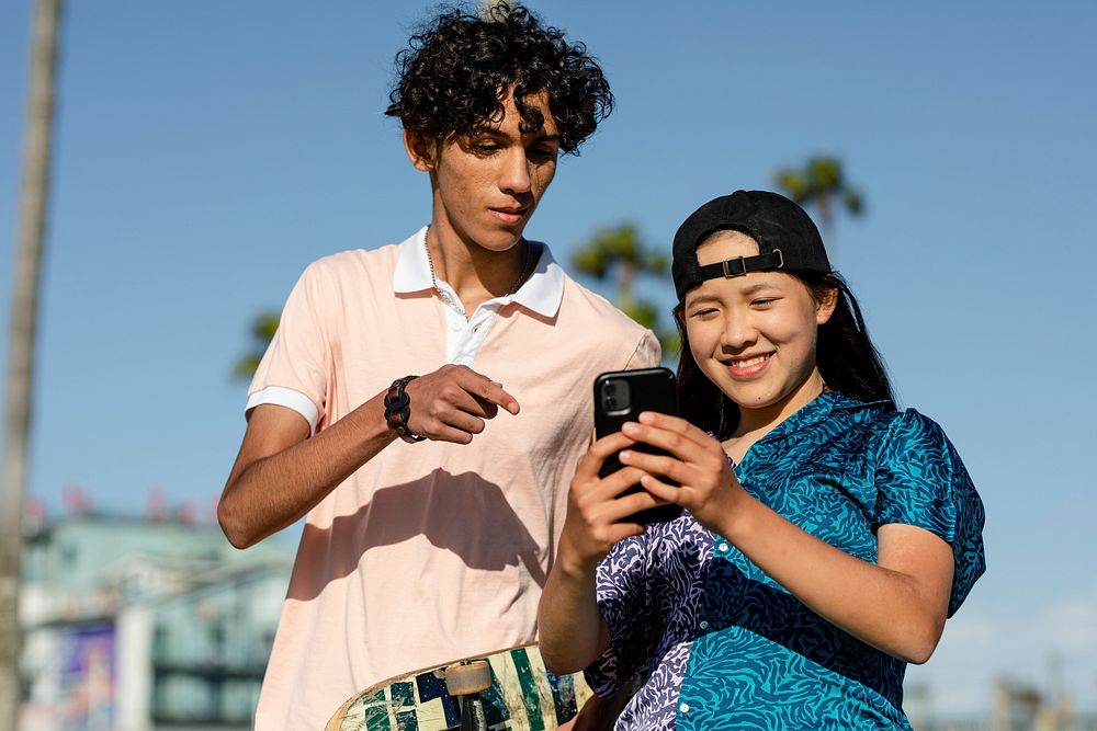 Teen couple take a selfie, summer in Venice Beach, Los Angeles