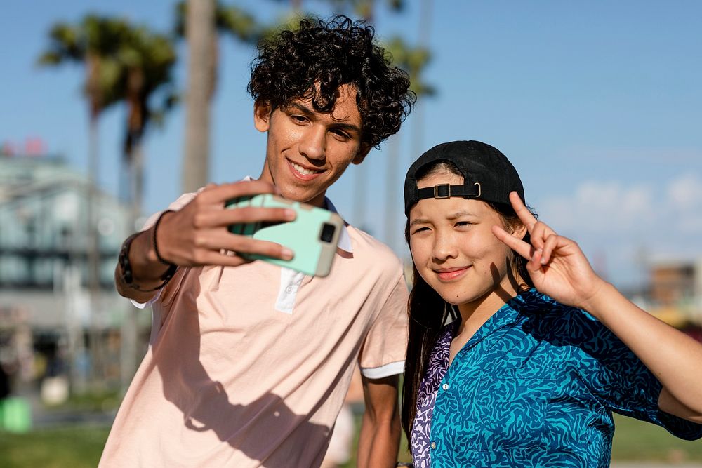 Cute teen couple take a selfie, summer in Venice Beach, Los Angeles