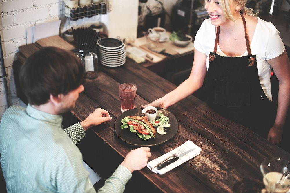 Serving a croissant sandwich at a cafe