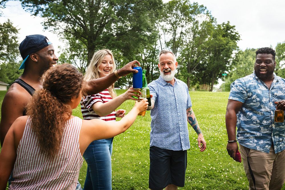 Cheers with beer at a summer party in the park