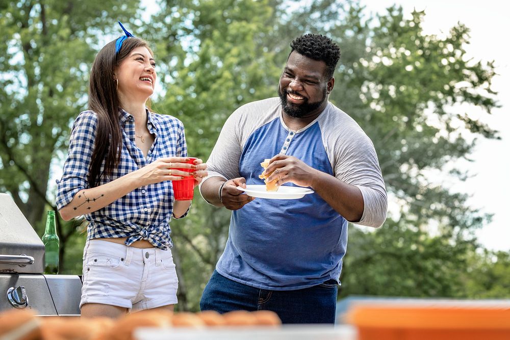 Friends having burgers at a tailgate party