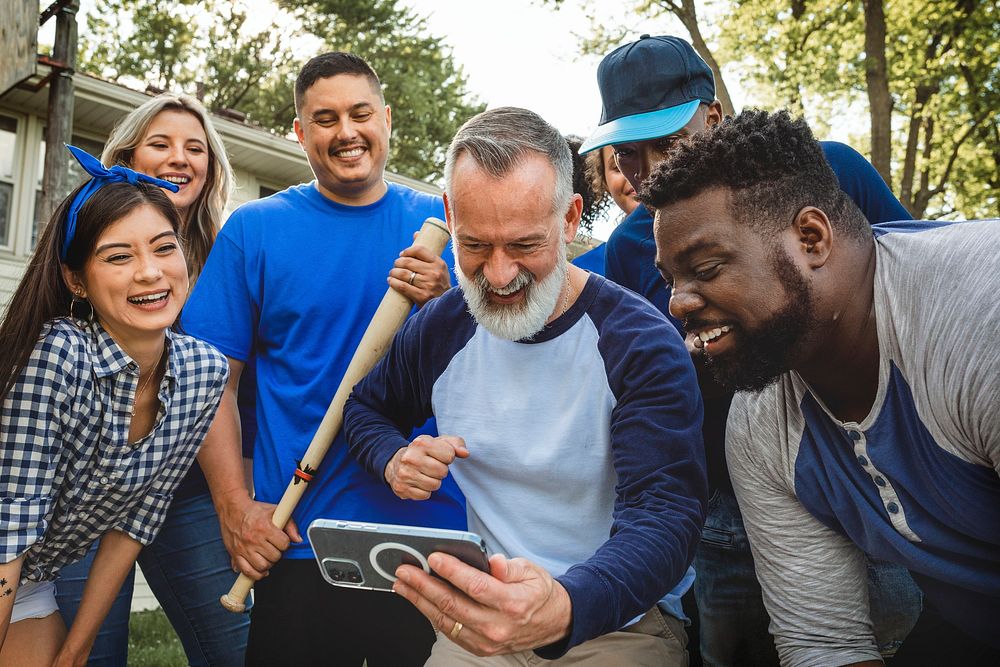 Baseball supporters watching their team win the game on a mobile phone