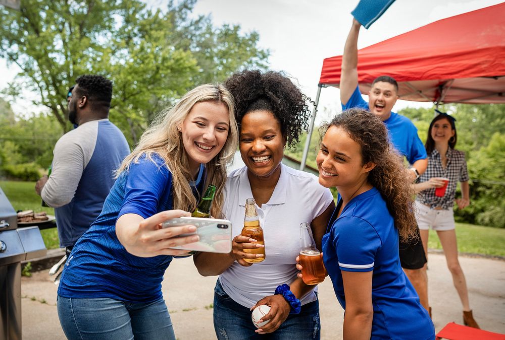 Friends taking a selfie at a tailgate party