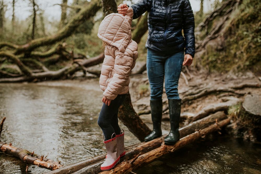 Family camping trip mother and daughter walking in the forest