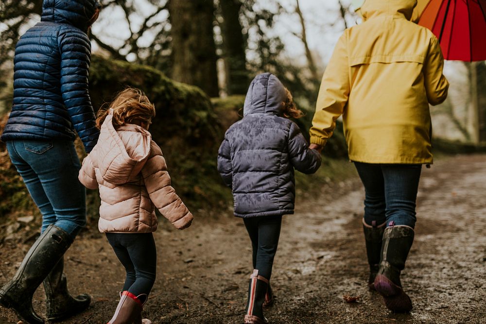 Family camping trip mother and daughter walking in the forest