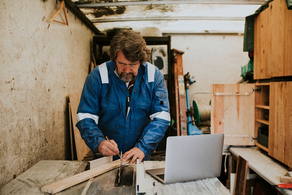 Senior carpenter working in his wood workshop