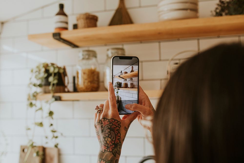 Woman taking a photo of kitchen home decor