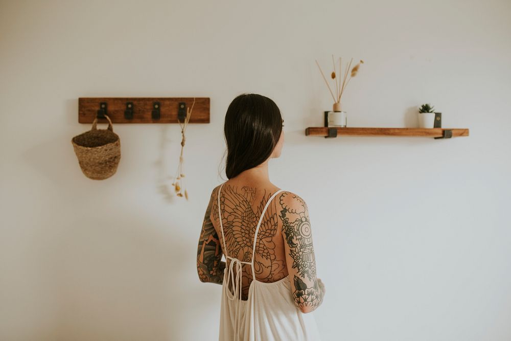 Minimal cozy home decor and a tattooed woman