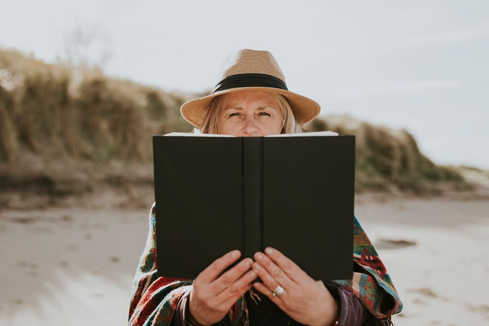 Senior woman enjoying her book on a holiday