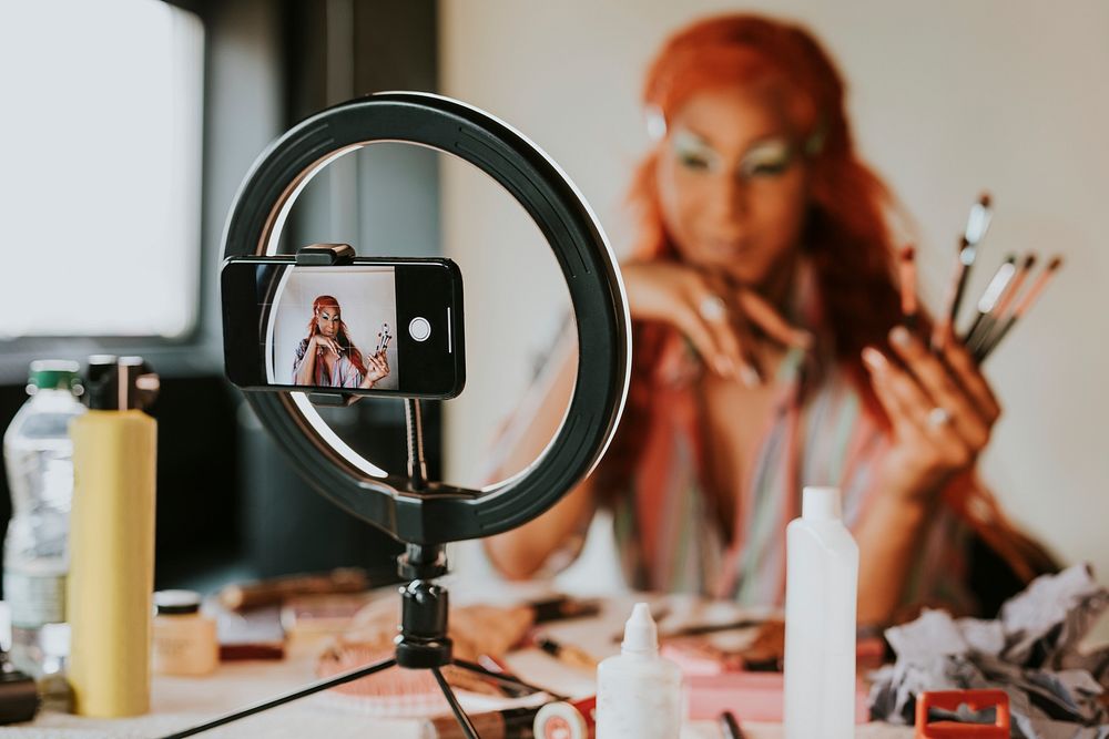 Drag queen beauty blogger recording a makeup tutorial video