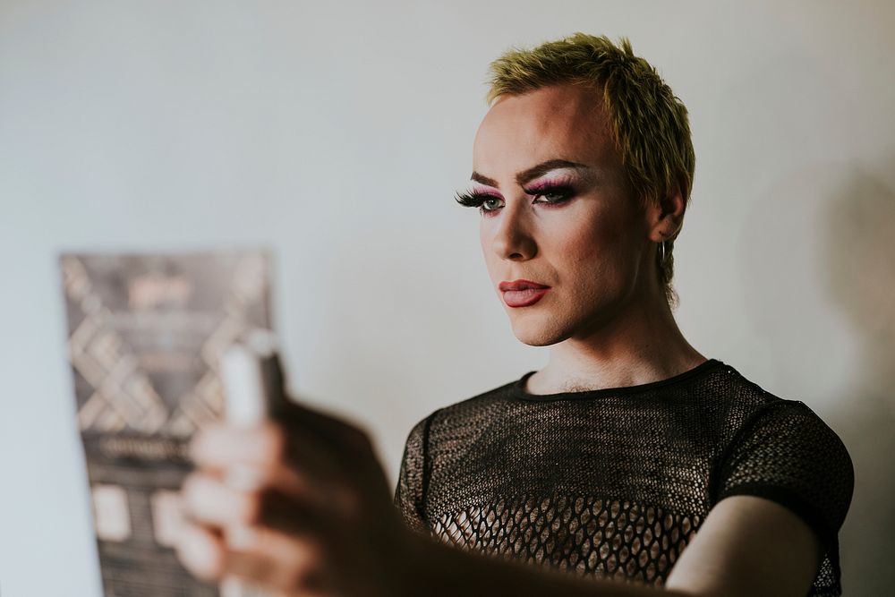 Glamorous LGBTQ+ beauty blogger, wearing makeup