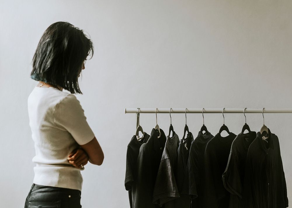 Woman selecting clothes from a clothing rack