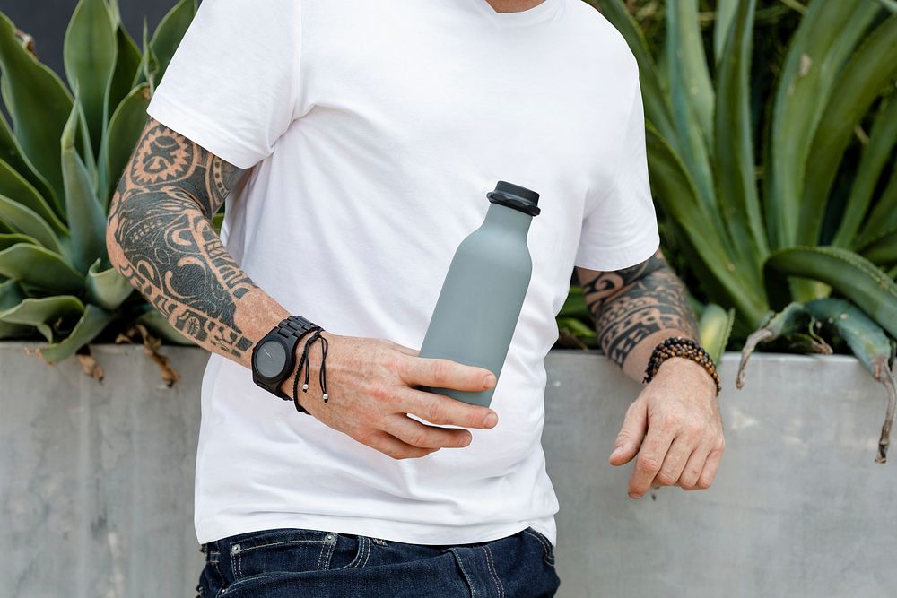 Tattooed man with gray insulated water bottle