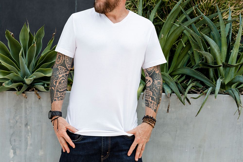 Tattooed man in white tee, casual wear apparel fashion
