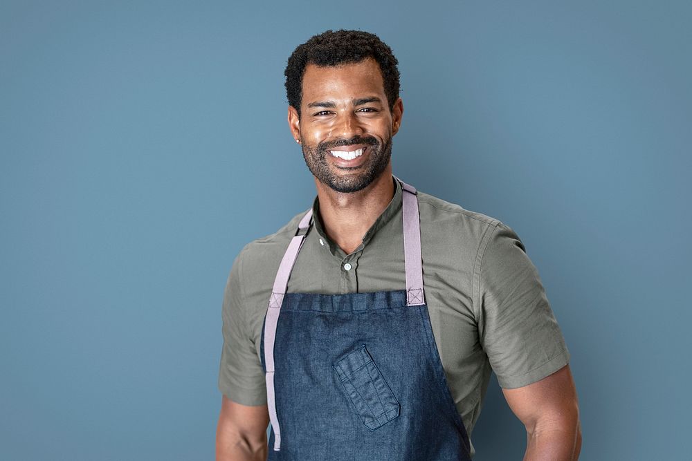 Cool small business owner in apron, half body