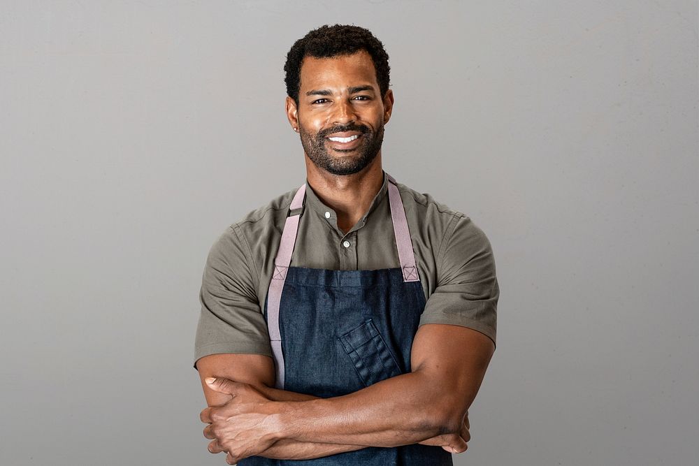 Cheerful man in apron, small business owner, half body