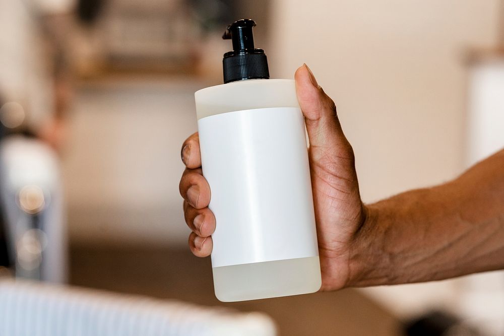 Barber with hair product, pump bottle with blank white label