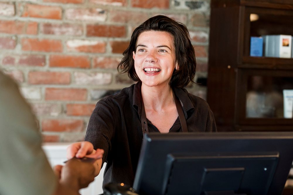 Receptionist taking payment for the customers