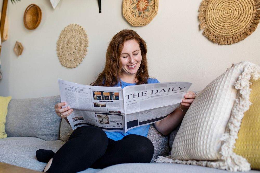 Woman reading newspaper in the morning