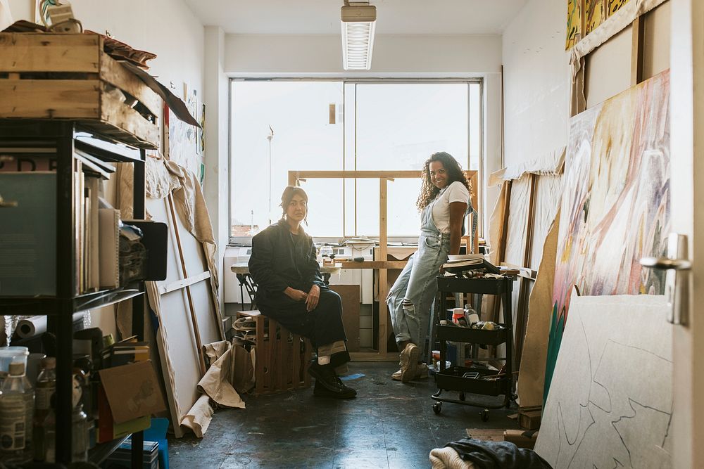 Woman artists sitting and relaxing inside of their art studio 