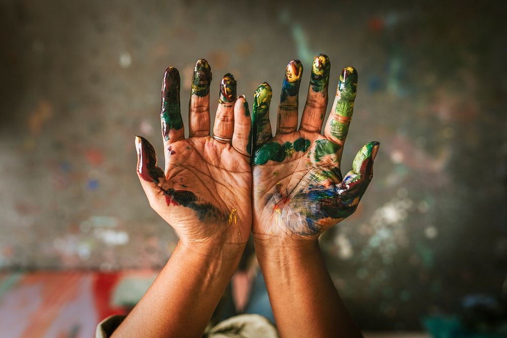 Hands covered in paint 