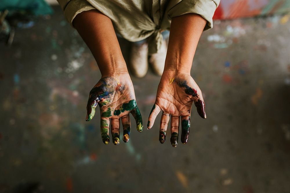 Hands covered in paint 