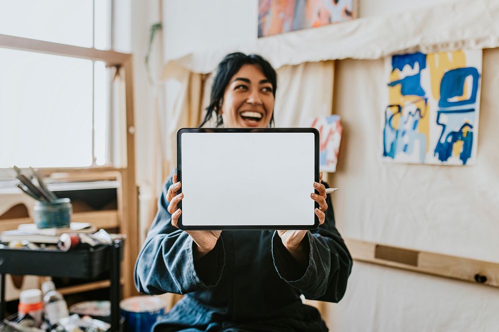 Woman artist showing blank digital tablet screen 