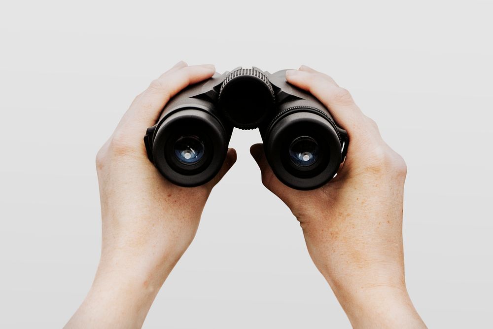 Spy holding binoculars, isolated on white psd