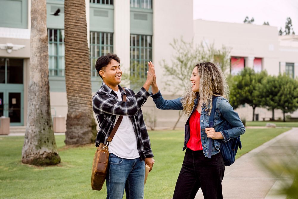 Students giving high five at university