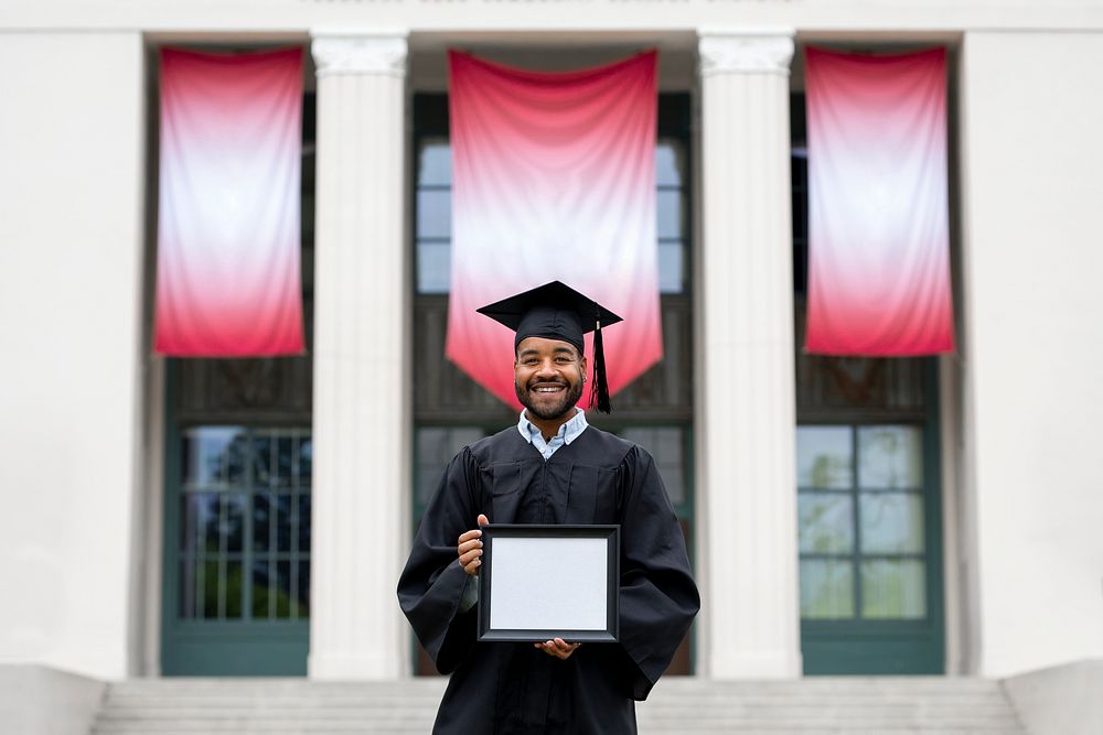 Graduating student holding blank frame