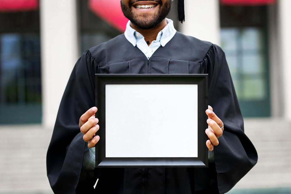 Graduating student holding blank frame