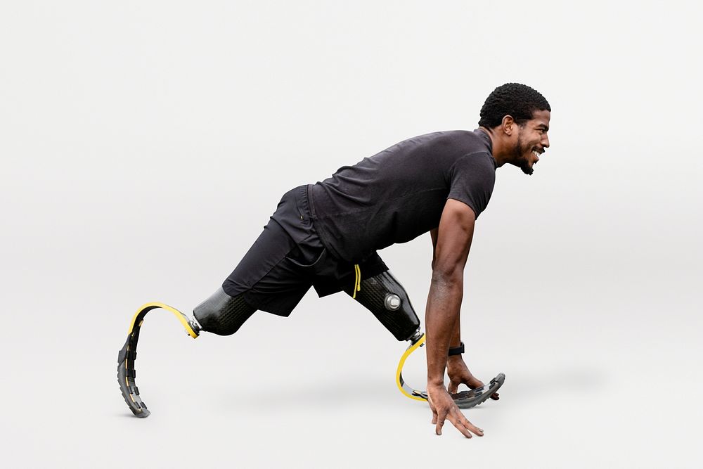 Paralympic athlete with prosthetic legs warming up by stretching before exercising psd