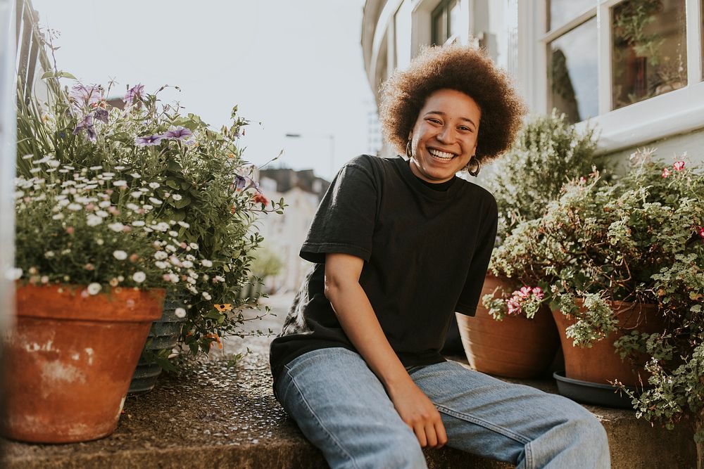 Woman smiling in a home garden, new normal hobby