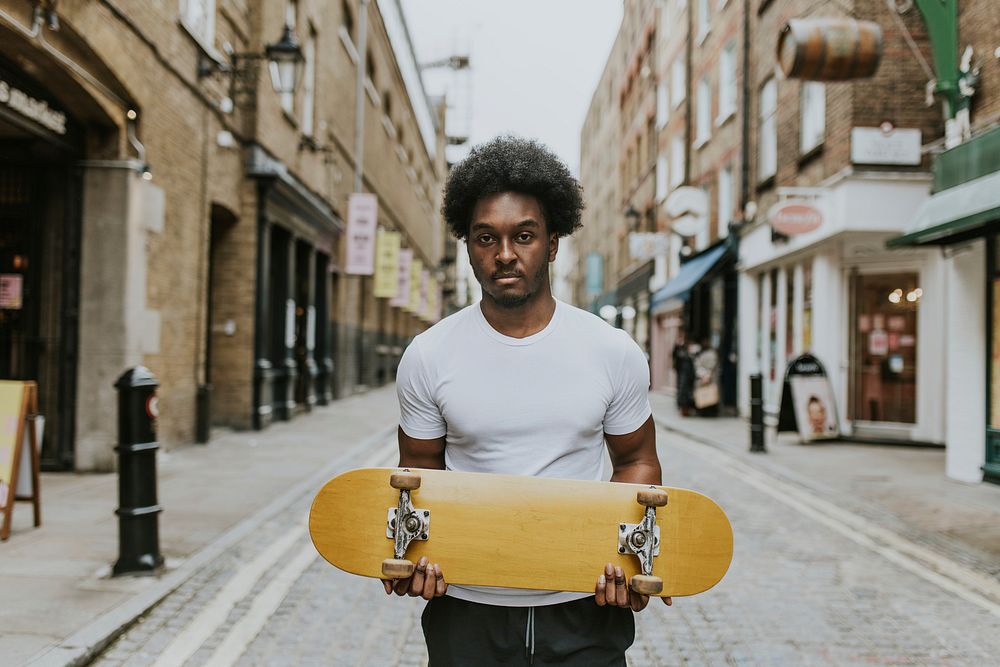 Man with wooden skateboard in town
