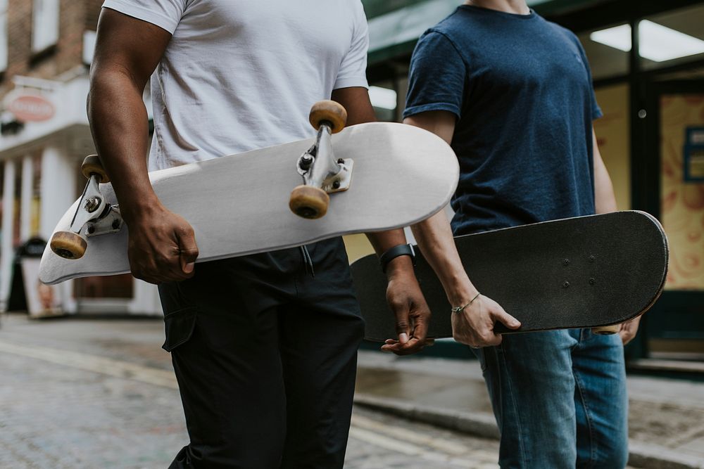 Men with skateboards, walking in alley