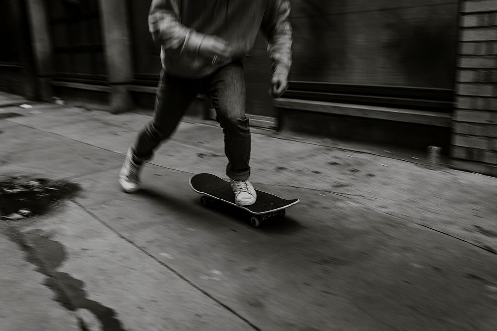 Man skating in city, black and white
