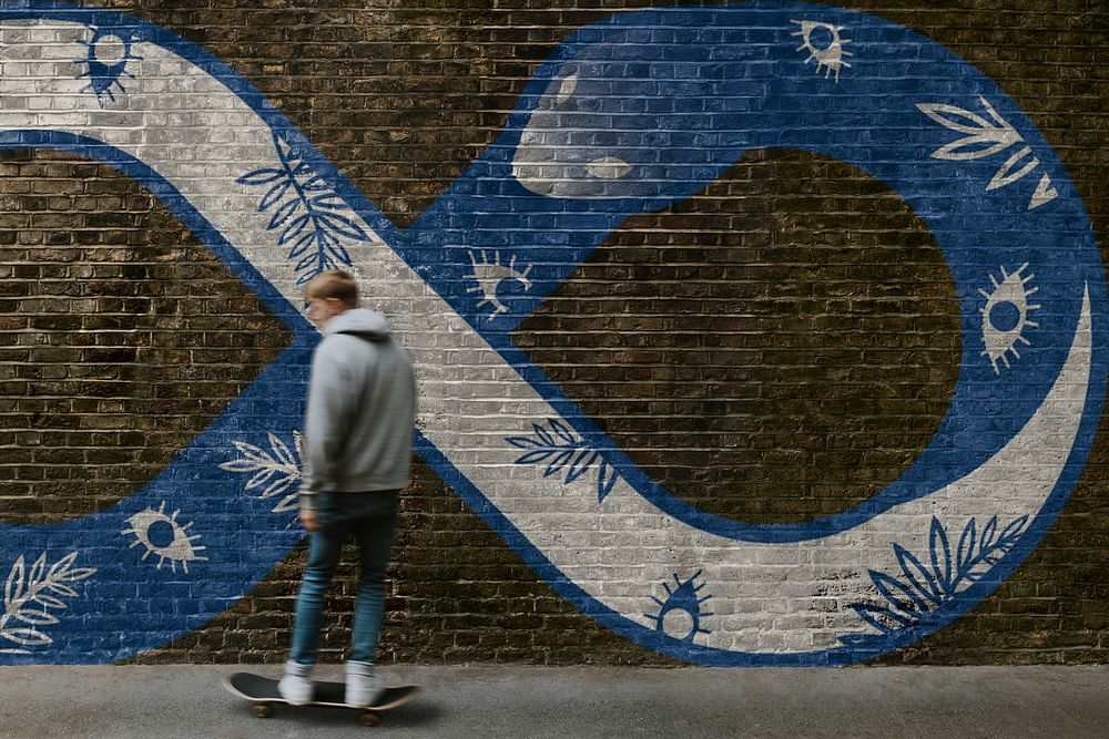 Brick wall mockup psd, blurred male skateboarder