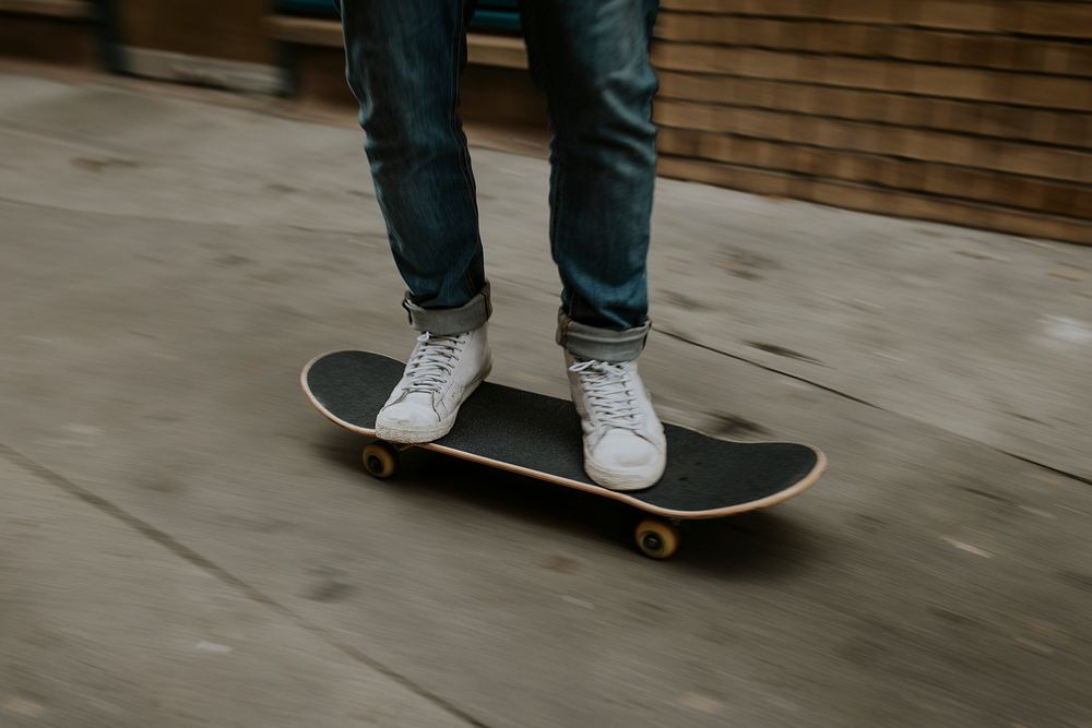 Man with white sneakers skating in city