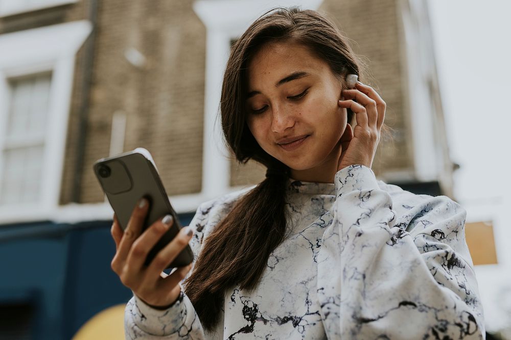 Woman listening to music with wireless earbuds