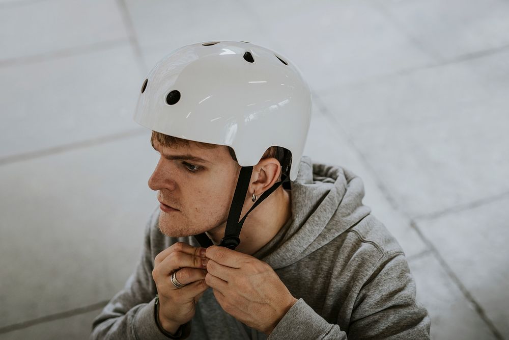 Man wearing white skate helmet, sports safety equipment