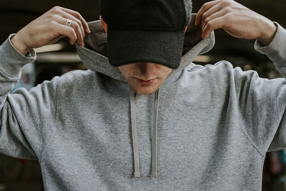 Man in gray hoodie with black cap